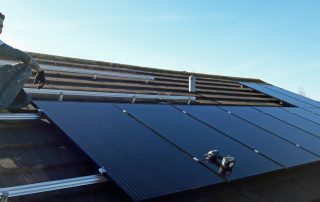 Solar panels being clamped to their rails (Image: T. Larkum)