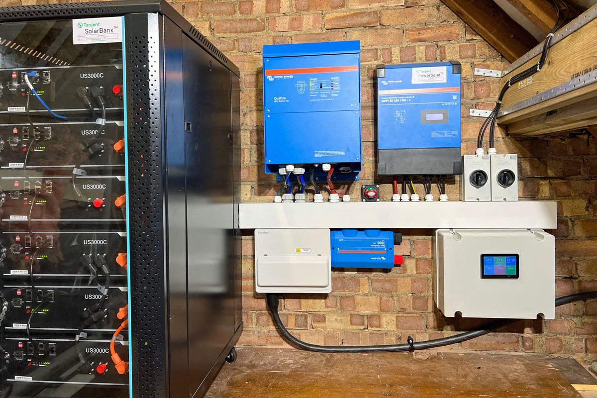 A large off-grid battery system with Victron Quattro 8000 centre, a Victron solar charge controller right, and 6 Pylontech US3000 batteries left